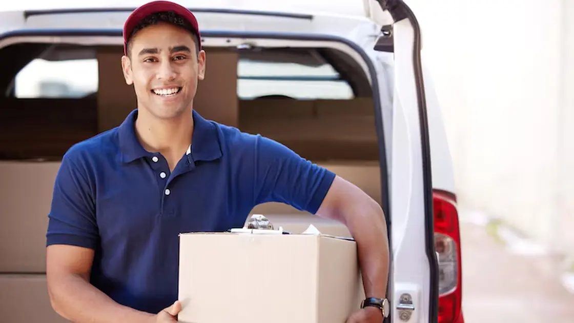 A driver with a delivery at the back of his van